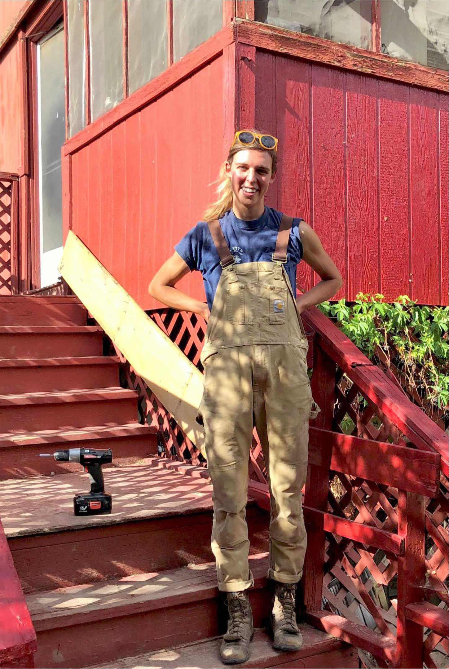 Woman smiling after she has just built her home deck